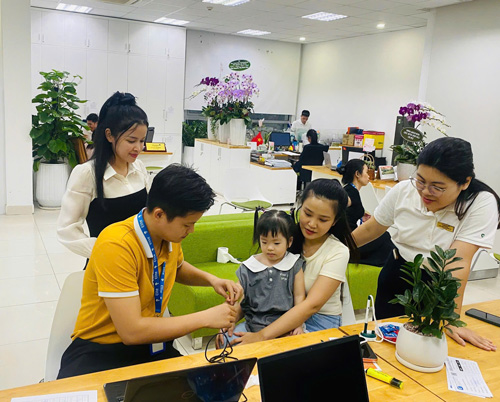 Chuyên viên sinh-trac-van-tay-elite-symbol hỗ trợ lấy mẫu vân tay cho bé.